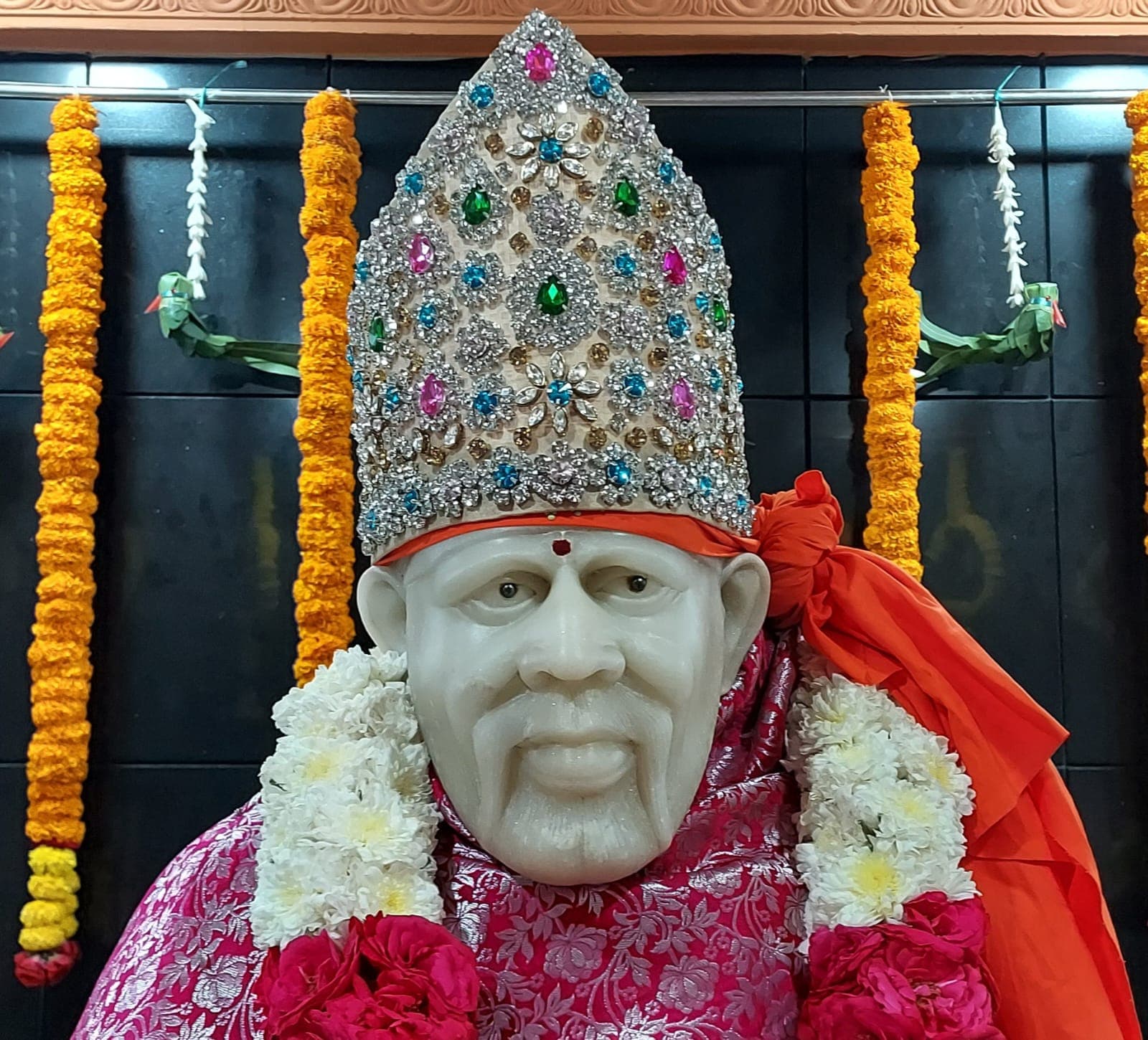Adorned murti with sacred garlands