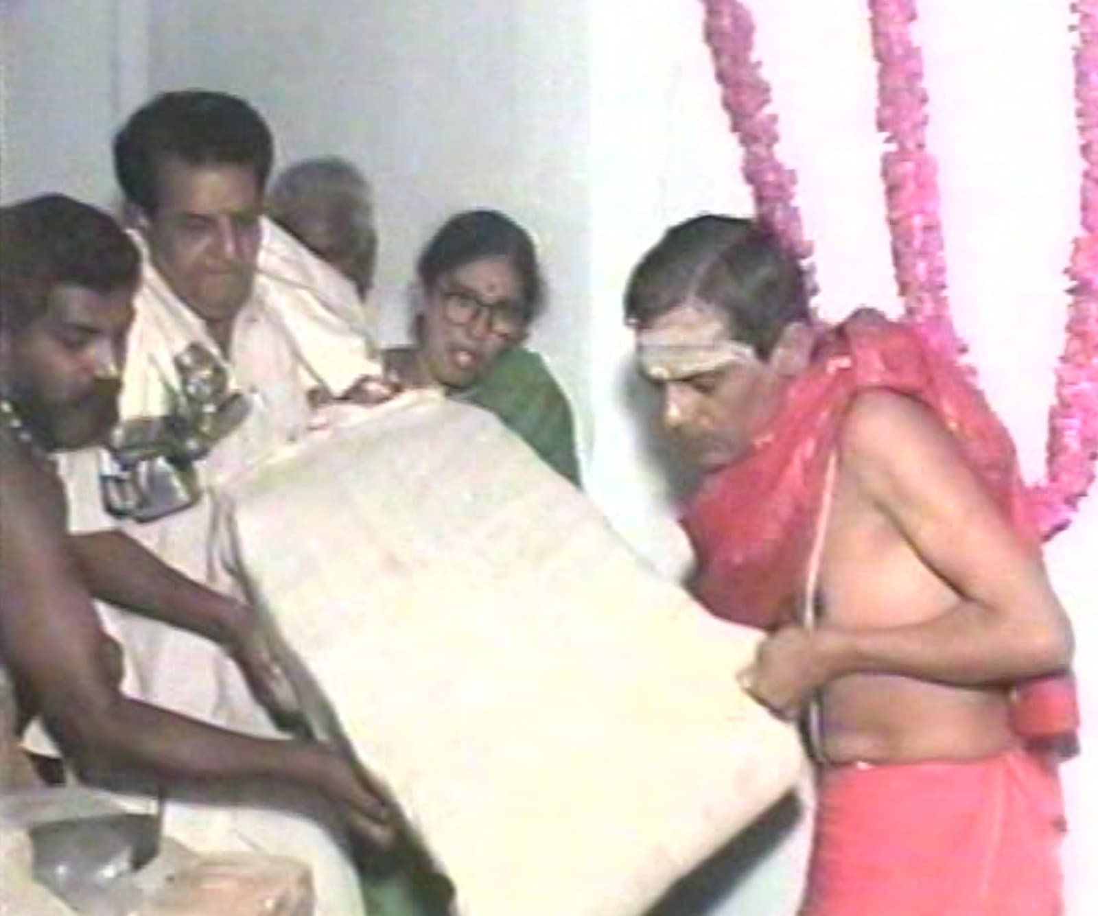 Archival 1997 photo of devotees carrying a marble slab during the consecration ceremony