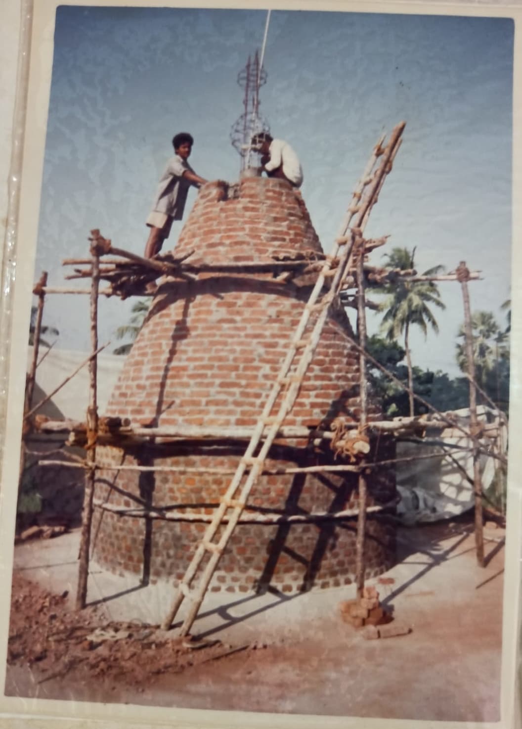 Workers completing the temple's gopuram (tower)