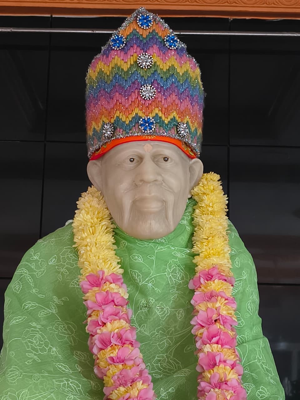 Close-up of the main murti, garlanded, present day