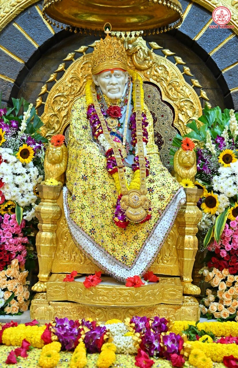 The Sai Baba murti at the Samadhi Mandir in Shirdi, garlanded and seated on a golden throne