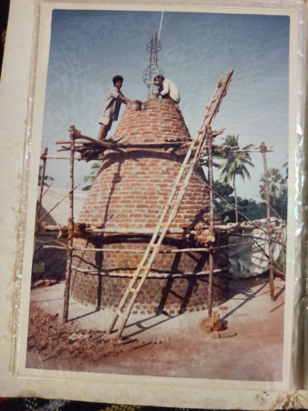 Workers completing the temple's gopuram (tower)