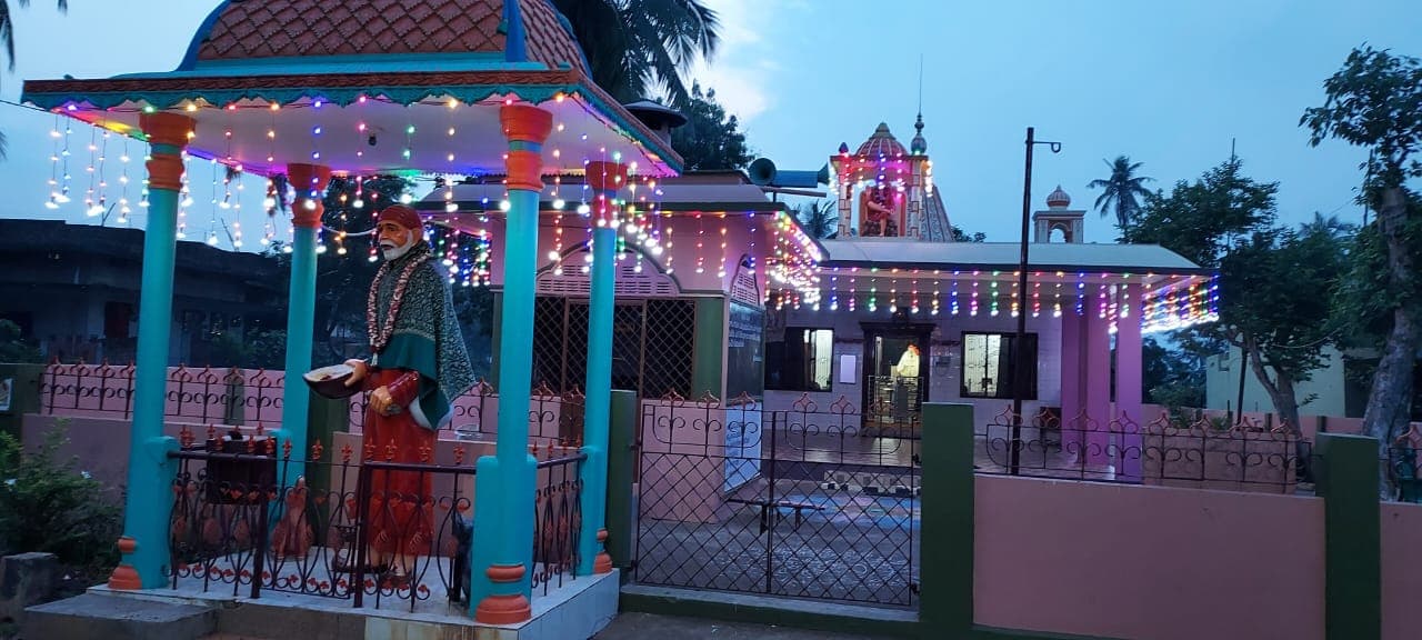 The temple's exterior, lit in the evening